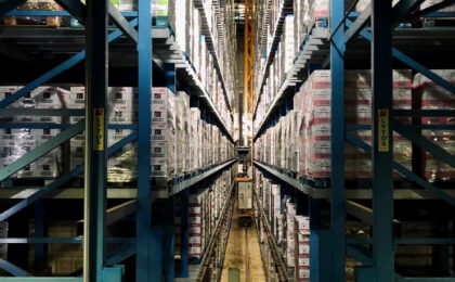 A warehouse interior, with shelves stretching into the distance